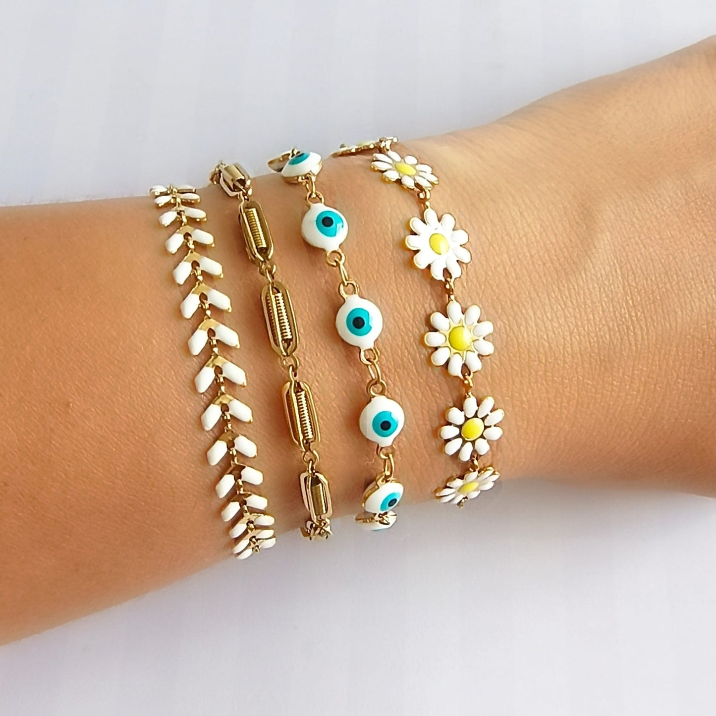 set pulseras mujer margaritas ojo turco doradas Brownika Accesorios