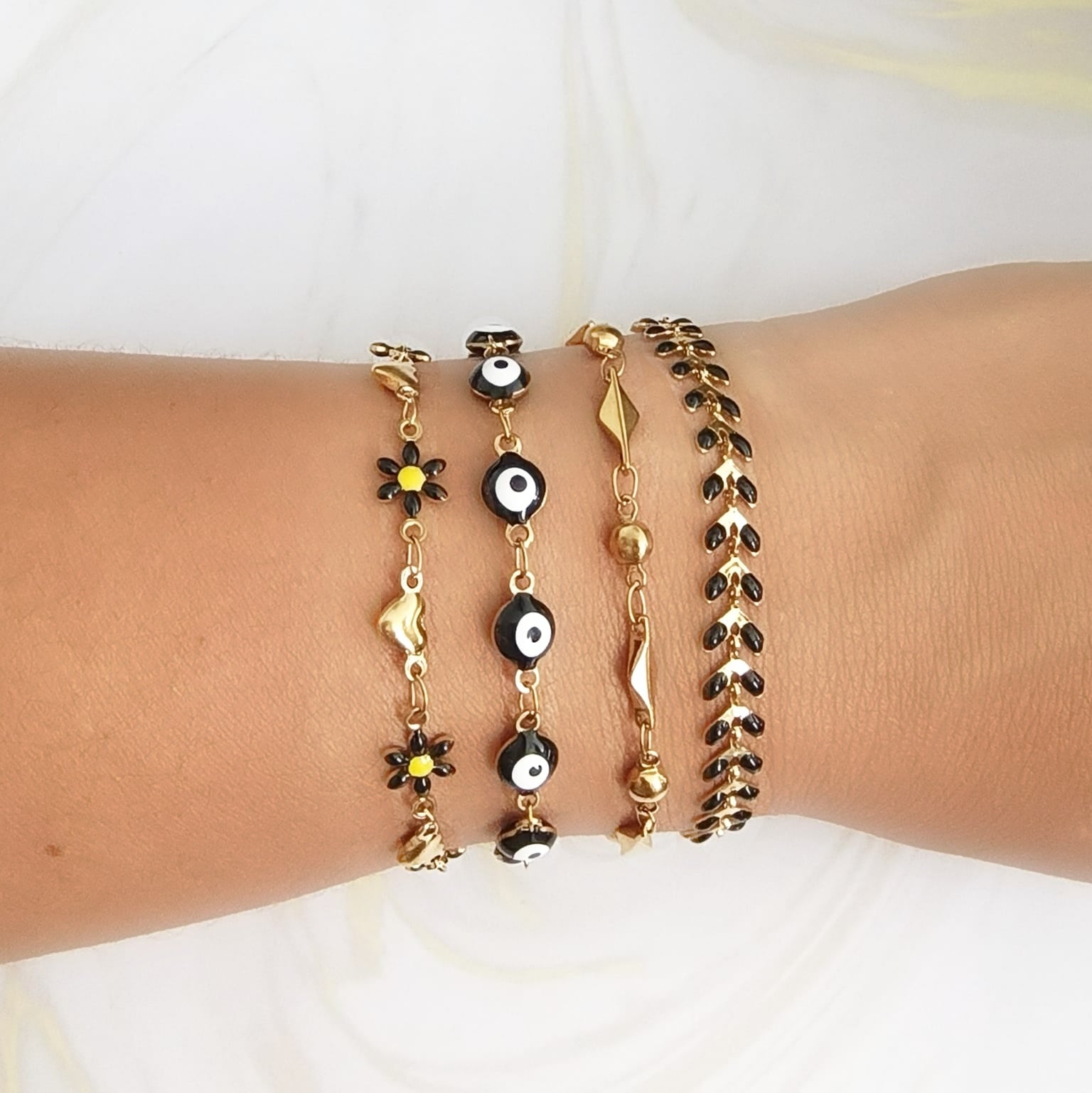 set pulseras mujer ojo turco flores negras doradas Brownika Accesorios